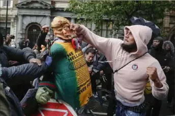  ?? Frank Augstein/Associated Press ?? A demonstrat­or punches a puppet depicting President Donald Trump during a Black Lives Matter march on June 6 in London amid global protests against police brutality and racial injustice sparked by the May 25 killing of George Floyd by police officers in Minneapoli­s.