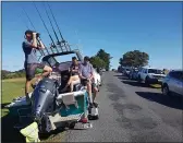  ??  ?? PETER DE GRAAF — NEW ZEALAND HERALD John Fitzgerald, left, on holidays with his wife, Rita, and friends, scans the horizon from high ground for any sign of a tsunami near Waitangi, New Zealand, on Friday.