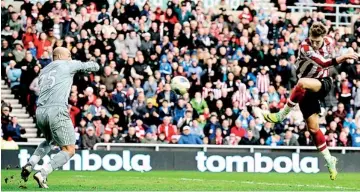  ??  ?? Sunderland's Nicklas Bendtner (R) shoots to score against Liverpool during their English Premier League soccer match in Sunderland, northern England March 10, 2012.