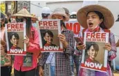  ?? AP ?? Anti-coup protesters display posters near the Indonesian embassy in Yangon, Myanmar, on Wednesday.