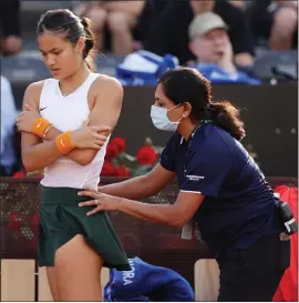  ?? ?? Emma Raducanu receives treatment on court for a back problem but she eventually had to retire in Rome