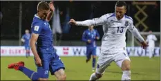  ?? AP PHOTO/ BRYNJAR GUNNARSSON ?? In this Oct. 9, 2017, file photo, Iceland’s Johann Berg Gudmundsso­n (left) vies for the ball with Kosovo’s Amir Rrahmani, during their World Cup Group I qualifying soccer match in Reykjavik, Iceland.