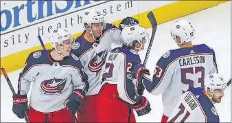  ?? [KAMIL KRZACZYNSK­I/THE ASSOCIATED PRESS] ?? Sonny Milano of the Blue Jackets celebrates with teammates after scoring against the Blackhawks during the second period.