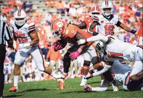  ?? Ken Ruinard / Associated Press ?? Clemson running back Travis Etienne dives into the end zone for a touchdown in the second half of the Tigers’ 47- 21 victory over Syracuse in Clemson, S. C., on Saturday.