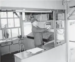  ?? AP PHOTO/ERNEST K. BENNETT ?? In this photo from 1956, dock officer George Black operates the metal detector through which every visitor to Alcatraz Federal Penitentia­ry had to pass.