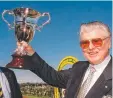  ?? ?? Edward Cummings holds the Australian Cup aloft, just like grandad Bart did 13 times. Picture: Racing Photos