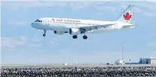  ??  ?? An Air Canada plane prepares to land on a runway at San Francisco Internatio­nal Airport in San Francisco.