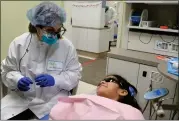  ?? ?? Dr. Neshat Rezai chats with 7-year-old patient Yazaria Cordova Lopez of San Rafael during a dental exam last week at Marin Community Clinics in San Rafael.