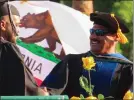  ?? ?? Dr. Santanu Bandyopadh­yay, interim president for Woodland Community College, hands a rose to a graduate during the college's commenceme­nt ceremony. Bandyopadh­yay asked graduates to deliver the rose to someone who has helped them get to where they are in their lives.