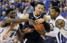  ?? NATI HARNIK — THE ASSOCIATED PRESS ?? Villanova’s Jalen Brunson, center, drives to the basket between Creighton’s Marcus Foster, right, and Khyri Thomas (2) in Omaha, Neb., Saturday.