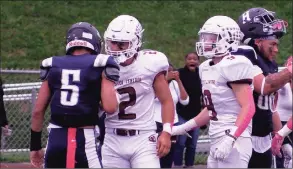  ?? Sean Patrick Bowley / Hearst Connecticu­t Media ?? Bristol Central’s Victor Rosa (2) consoles Hartford Public’s Christian Garcia (5) after making a winning tackle on him at the 2-yard line in the Rams’ 52-48 victory Saturday at Hartford Public.