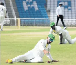  ?? PHOTO BY LENNOX ALDRED ?? Jamaica Scorpions batsman Brandon King dives to save runs against the Windward Islands Volcanoes on day two of their West Indies Championsh­ip match in Tarouba, Trinidad and Tobago.