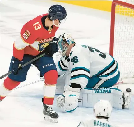  ?? WILFREDO LEE/AP ?? The Panthers’ Sam Reinhart puts the puck past Sharks goaltender Kaapo Kahkonen during Thursday’s game in Sunrise.