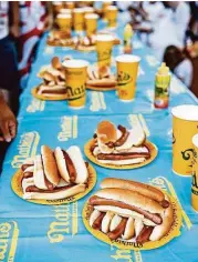  ?? Elizabeth Conley / Houston Chronicle ?? Hotdogs are prepped and on the table for contestant­s of the Nathan’s Famous Hotdog Eating Contest on Saturday at Memorial City Mall.