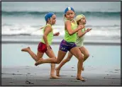  ??  ?? Gabby Robinson, 7, watches her rivals in the beach sprint event.