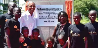  ?? KARUMBA/AFP/GETTY IMAGES
TONY ?? Former President Barack Obama poses for a photograph with local young beneficiar­ies on Monday during the opening of the Sauti Kuu Resource Centre, founded by his half-sister, Auma Obama, in western Kenya.