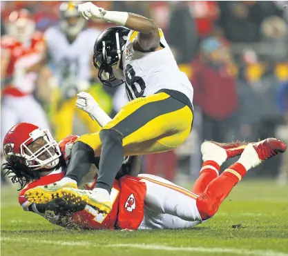  ??  ?? Pittsburgh’s Bud Dupree, top, crashes into Chris Conley of Kansas City.