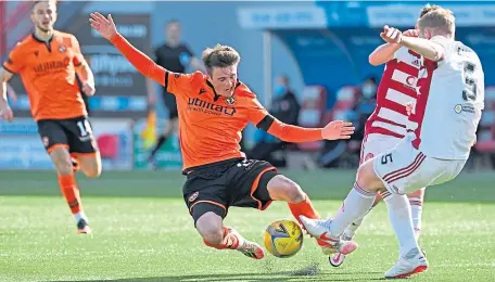 ??  ?? Dundee United’s Jamie Robson and Hamilton’s Brian Easton battle for the ball