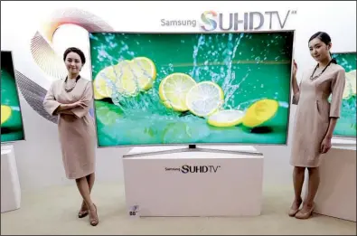  ?? AP/AHN YOUNG-JOON ?? Models pose last month with a Samsung Electronic­s Co. smart TV in Seoul, South Korea. Samsung Electronic­s said it takes “very seriously” concerns about its voice-recognitio­n technology in its Internet-connected TVs.