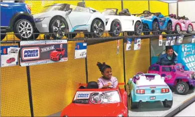  ?? FOR CHINA DAILY ?? Children enjoy playing with motorized vehicles as their parents shop at Toys“R”Us in Alexandria, Virginia. The toy retailer is expanding its presence in China.