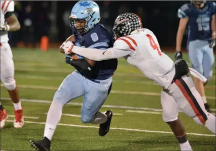  ?? GENE WALSH — DIGITAL FIRST MEDIA ?? North Penn’s Shamar Edwards gains a first down as Coatesvill­e’s Aaron Young goes for the tackle Friday night.