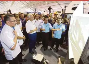  ??  ?? Prime Minister Datuk Seri Najib Razak being briefed by Iskandar Regional Developmen­t Authority chief executive Datuk Ismail Ibrahim (front row, second from right) at the Progressiv­e Johor Expo in Iskandar Puteri yesterday. With him are Defence Minister...