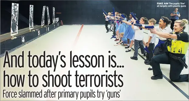  ??  ?? FAKE AIM The pupils ‘fire’ at targets with plastic guns