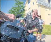  ?? PHOTOS BY BLOOMBERG ?? Former Vice President Mike Pence, centre, gets on a motorcycle during the Roast and Ride hosted by Senator Joni Ernst in Des Moines, Iowa, US on Saturday.