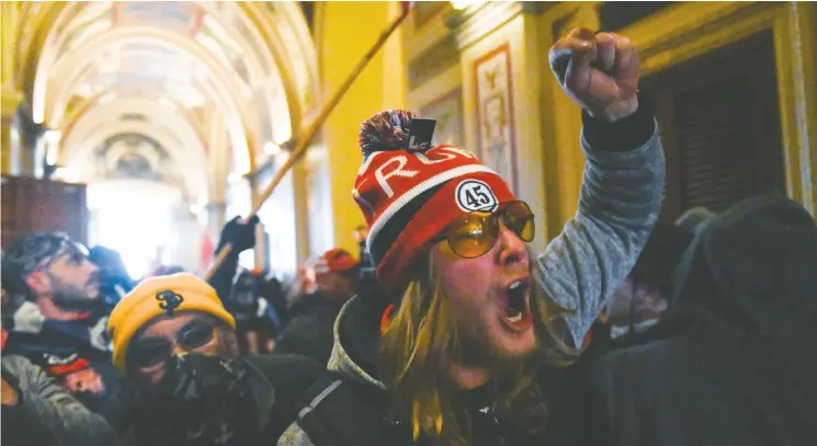  ?? ROBERTO SCHMIDT / AFP via Gett y Images ?? Supporters of U. S. President Donald Trump protest inside the Capitol on Wednesday in Washington, D.C., as demonstrat­ors easily breeched security and stormed the building.