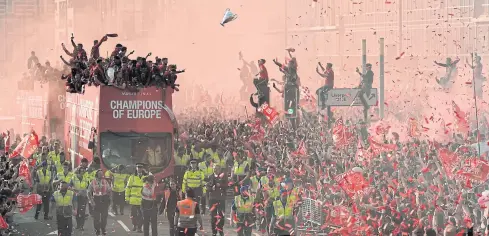  ?? AFP ?? Football fans line the streets during Liverpool’s open top bus parade in the city after winning the Champions League.