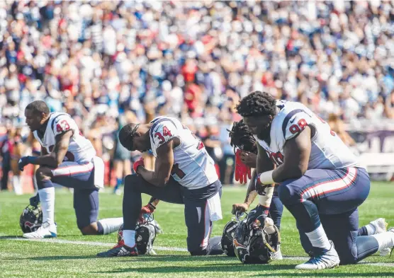  ?? SOLIDARITY: Houston Texans players kneel before the game against the New England Patriots on Sunday in a protest against President Donald Trump. Picture: GETTY ??