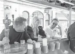  ??  ?? 'The Late Late Show' host James Corden, left, enjoys a libation break with actors Sophie Turner and James McAvoy during a double-decker bus tour on the CBS late-night program's latest London visit. CRAIG SUGDEN, CBS