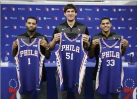  ?? MATT ROURKE — THE ASSOCIATED PRESS ?? From left to right, Philadelph­ia 76ers’ Mike Scott, Boban Marjanovic and Tobias Harris, pose for photograph­s during a news conference at the team’s practice facility in Camden, N.J., Thursday.