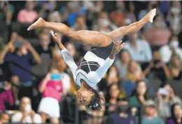  ?? ERIN HOOLEY AP ?? Simone Biles performs on the balance beam at the U.S. Classic gymnastics competitio­n Saturday in Hoffman Estates, Ill. Biles finished first at the meet.