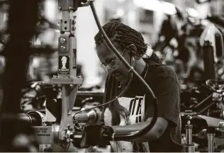  ?? Jose M. Osorio / Tribune News Service file photo ?? A worker labors on the assembly line in June 2019 at the Ford Chicago Assembly Plant where the Ford Explorer, Lincoln Aviator and Police Intercepto­r sport utility vehicles are built.