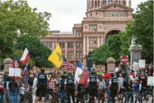  ?? Photos by Stephen Spillman / Contributo­r ?? Protesters gather Saturday at the Texas Capitol in Austin to call for an end to social and economic restrictio­ns aimed at slowing the spread of the coronaviru­s.