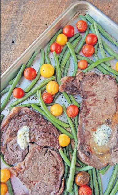  ?? [CRISTINA M. FLETES/ST. LOUIS POST-DISPATCH] ?? Delicious and easy to make: rib-eye steaks with blue cheese butter and vegetables