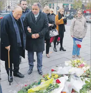  ?? AP PHOTO ?? Paris mosque rector Dalil Boubakeur, left, pays his respects to the victims of the Nov.13 attacks, at the Place de la Republique in Paris, Friday.
