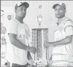  ??  ?? Lusignan ‘A’ vice-captain, Somdatt Bharrat (left) and Enmore CCCC captain, Beemraj Ramkelawan pose with the trophy.