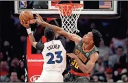  ?? AP-Todd Kirkland ?? Minnesota Timberwolv­es guard Jarrett Culver (23) battles against Atlanta Hawks center Damian Jones (30) in the first half of an NBA basketball game in Atlanta on Monday.