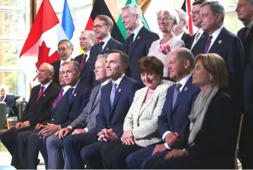  ?? . — Reuters photo ?? Delegates pose for an official photo at the G7 Finance Ministers Summit in Whistler, British Columbia, Canada. Washington’s main allies delivered a unified message of shock and dismay at a G7 ministeria­l meeting during the weekend, urging US President...