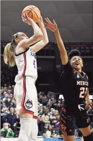  ?? Jessica Hill / Associated Press ?? UConn’s Paige Bueckers shoots over Mercer’s Shannon Titus during a first-round game in the NCAA Tournament on Saturday in Storrs.