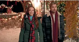  ?? ?? Lohan and Chord Overstreet in Falling for Christmas.