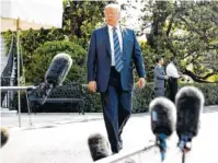  ?? THE ASSOCIATED PRESS ?? President Donald Trump approaches the microphone­s to speak to the media as he walks to the Marine One helicopter Friday.