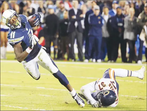  ??  ?? San Diego Chargers wide receiver Steve Johnson (left), falls forward after a reception as Chicago Bears cornerback Bryce Callahan (37) defends during the
second half of an NFL football game, Nov 9, in San Diego. (AP)