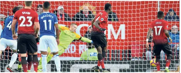  ?? — Reuters ?? Close strike: Manchester United’s Paul Pogba scoring the first goal against Everton in a Premier League match on Sunday. Below: Pogba (right) and Anthony Martial discussing their strategy during the match.