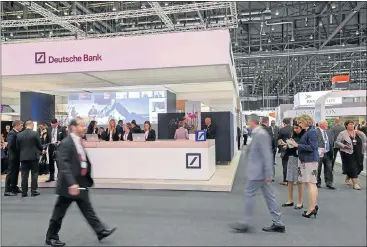  ?? Picture: EPA ?? NO STEADY PACE: Visitors and exhibitors gather at the Deutsche Bank booth, during the Swift Internatio­nal Banking Operations Seminar 2016 at the Palexpo in Geneva, Switzerlan­d, on Monday. The bank’s shares lost 6% in afternoon trade bringing losses to about 52% in 2016.