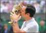  ?? ALASTAIR GRANT / AP ?? Roger Federer kisses the Wimbledon trophy on Sunday.