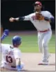  ?? KATHY WILLENS — THE ASSOCIATED PRESS ?? Philadelph­ia Phillies shortstop Freddy Galvis (13) throws to first after forcing out New York Mets’ Asdrubal Cabrera (13) Sunday in New York.