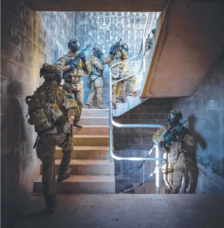  ?? ?? Australian Army 3RAR soldiers conduct a building clearance during an urban assault.